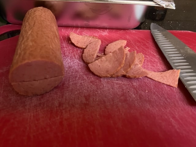 slicing the salami into half moon slices