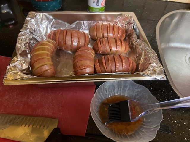 brushing the sweet chili sauce on potatoes