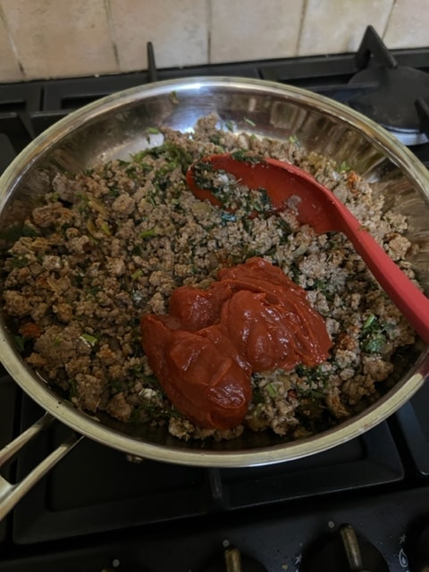 adding the tomato paste