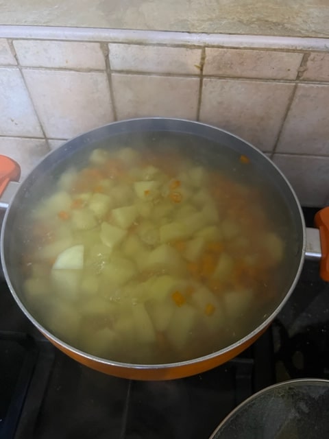 Cooking the cubed potatoes and small chunked carrots