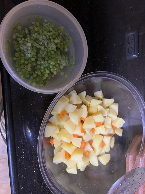 Put drained potatoes and carrots in bowl while peas defrost