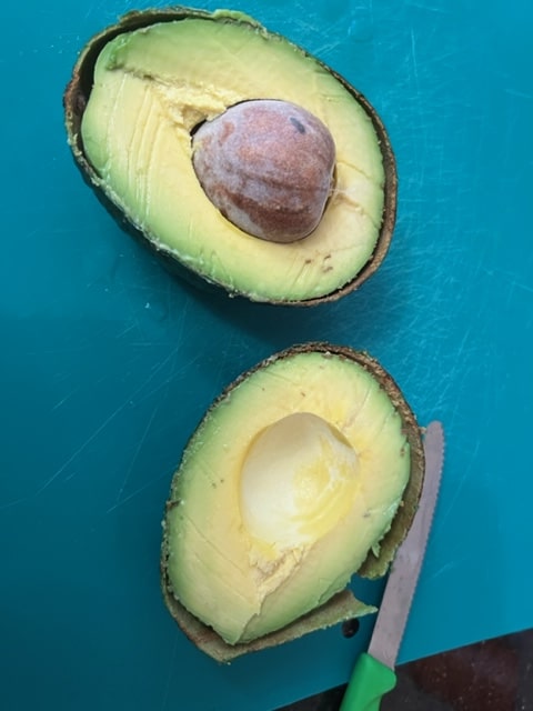beautiful ripe avocado sliced in half