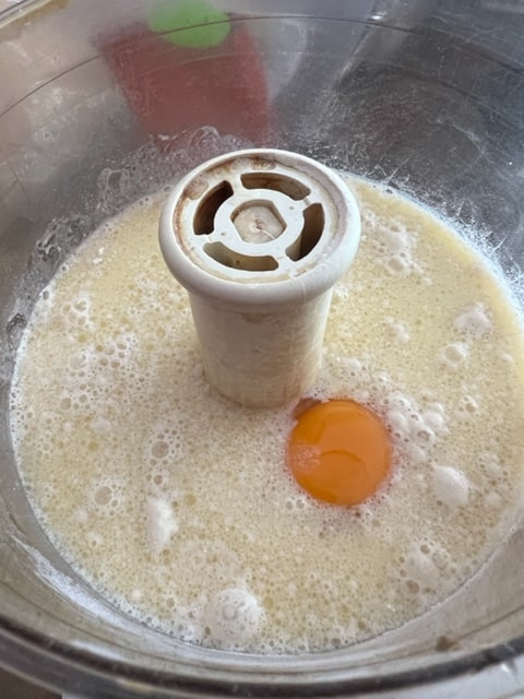 adding the egg and milk to flour, sugar salt