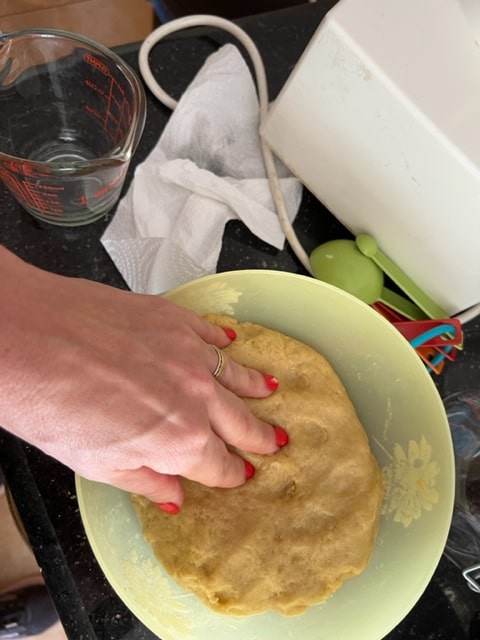 kneading the dough in the bowl