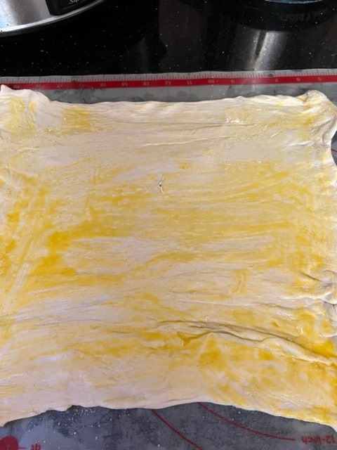 brushing pastry with beaten egg
