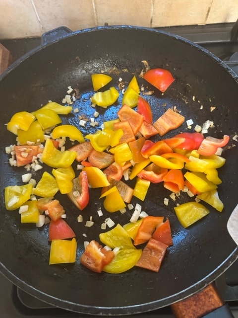 adding the pepper to the garlic and onion