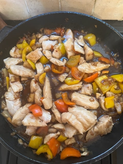 adding the chicken to the sauce