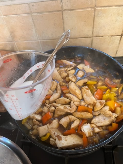 Adding the cornstarch mixture to the chicken and sauce
