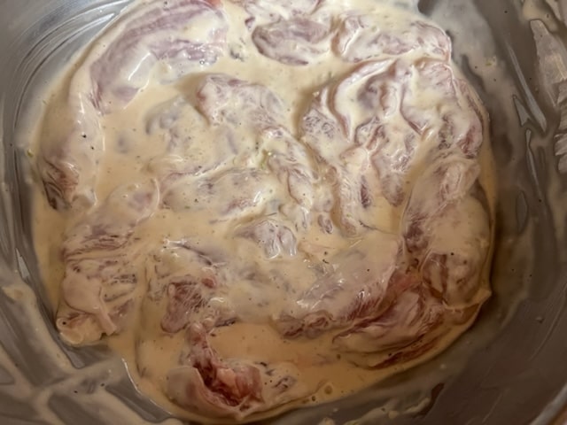 coating the chicken in the marinade
