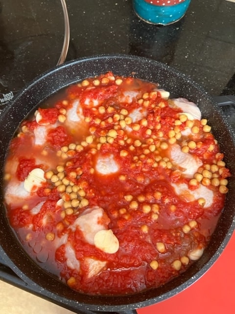 pour the tomato, wine and chickpeas over