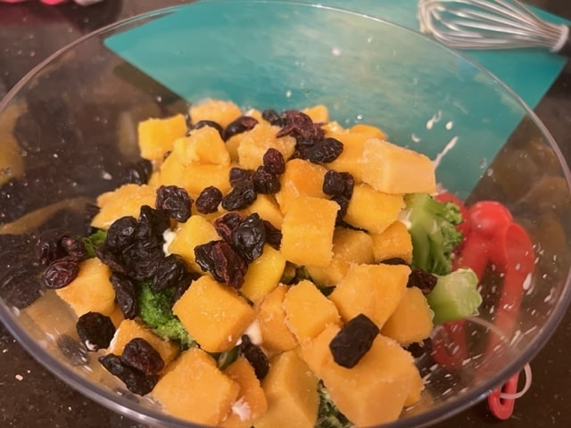 Add broccoli, mango and dried fruit