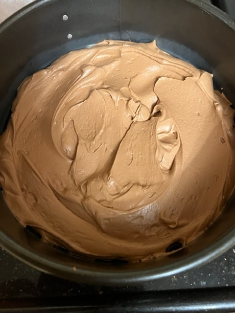 spreading the mousse in the pan for baking