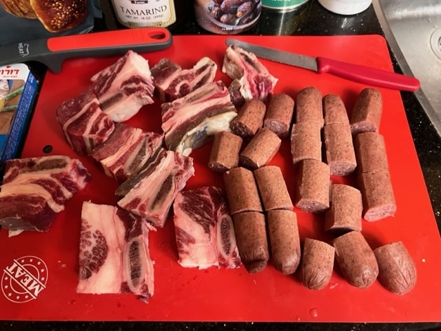beef ribs and sausage cut up in chunks.