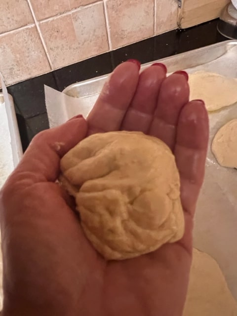 scooping a handful of dough