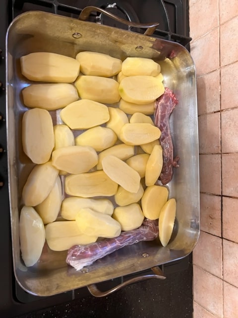 bottom of roaster with potatoes