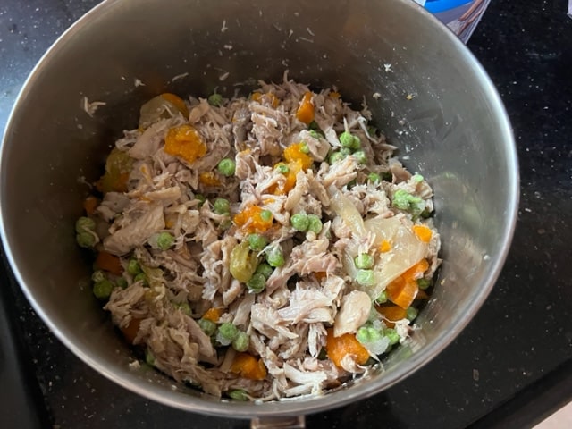 adding the veggies to the chicken