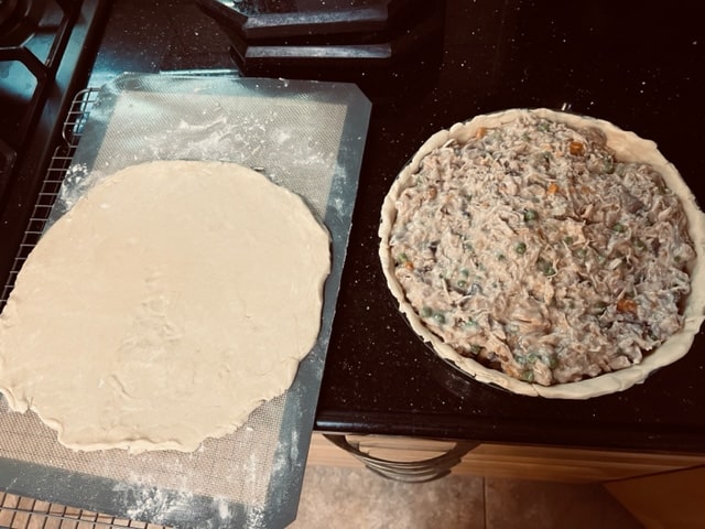 Filling the crust with chicken/veg mix