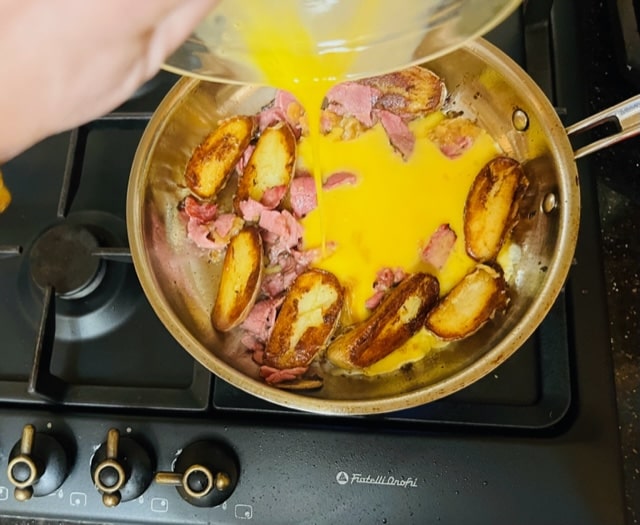 pouring the eggs over the lot