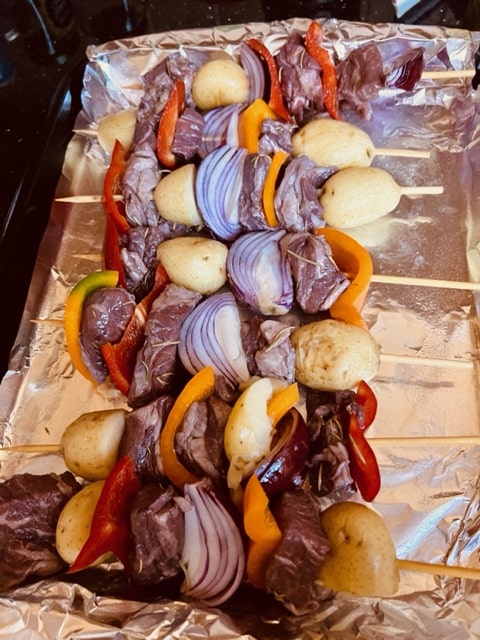 threading the meat and veg on the skewers