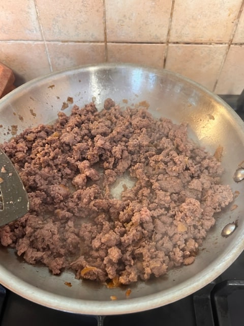 cooking the beef into crumbles