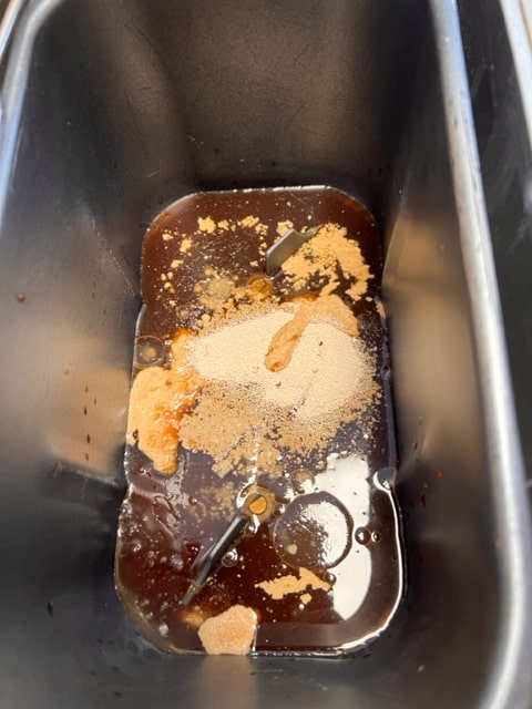 mixing the water, molasses, coffee, oil and yeast
