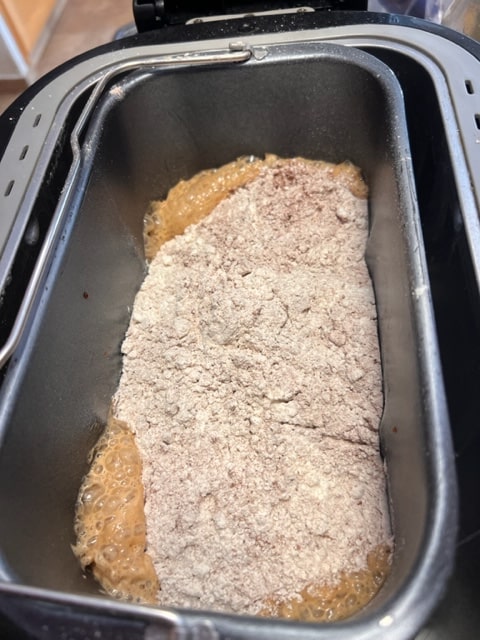 adding flour mixture to yeast mixture