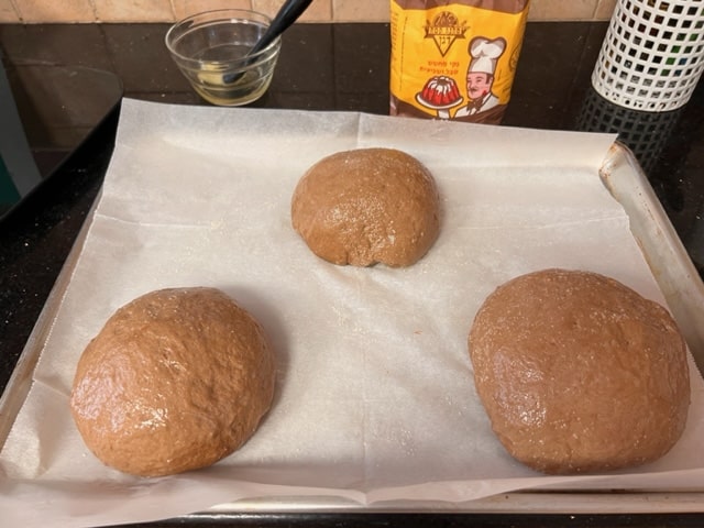 Placing 3 dough rounds on parchment paper on baking sheet