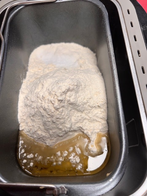 adding the flour, salt, rest of water and oil