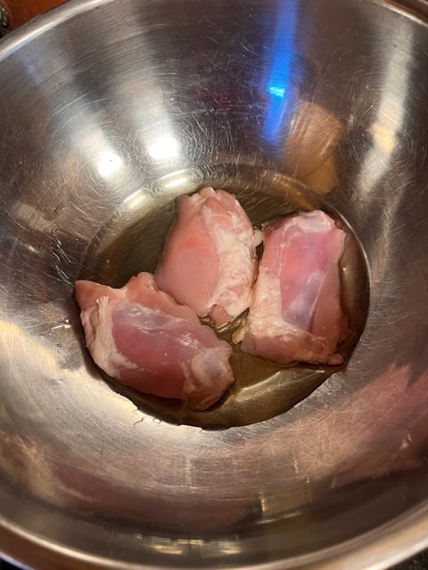 halved skinless, boneless chicken thighs in oil