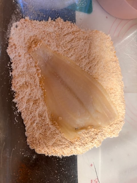 Place the egged fish into the breadcrumb mixture