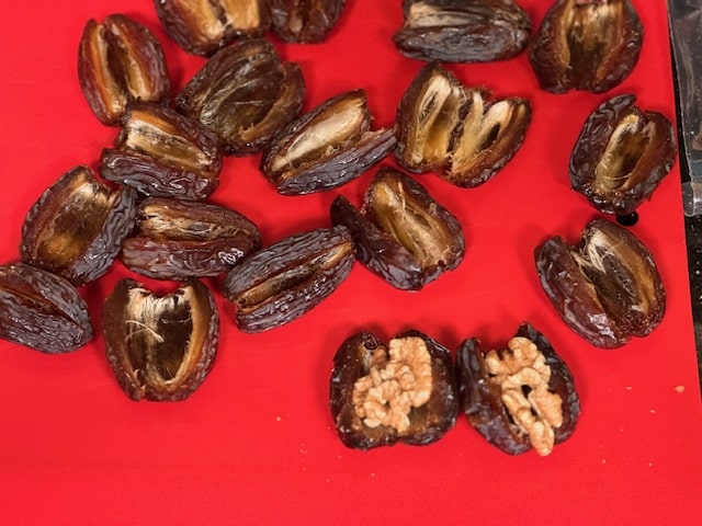 pit the dates and stuff with the toasted walnuts