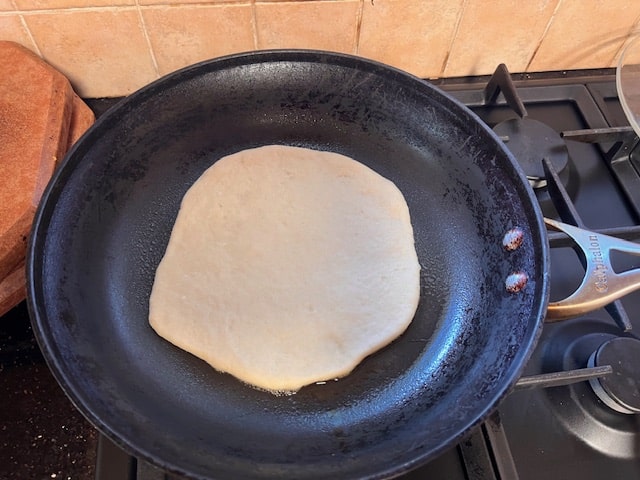 putting the flatbread on the pan
