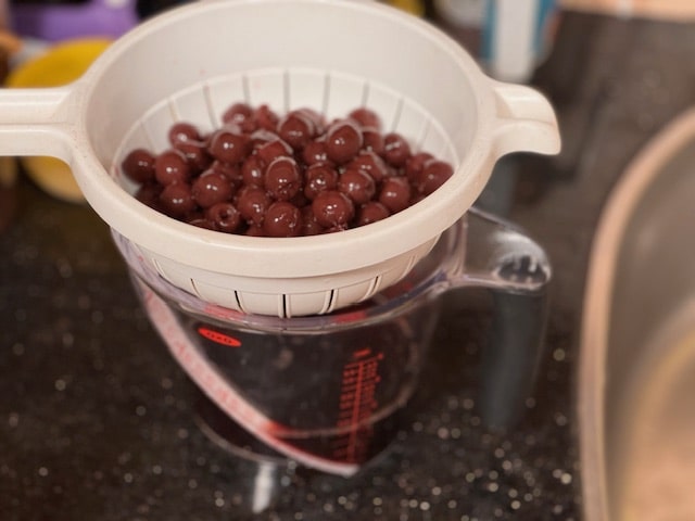 drain the cherries over a bowl or measuring cup to catch the juices
