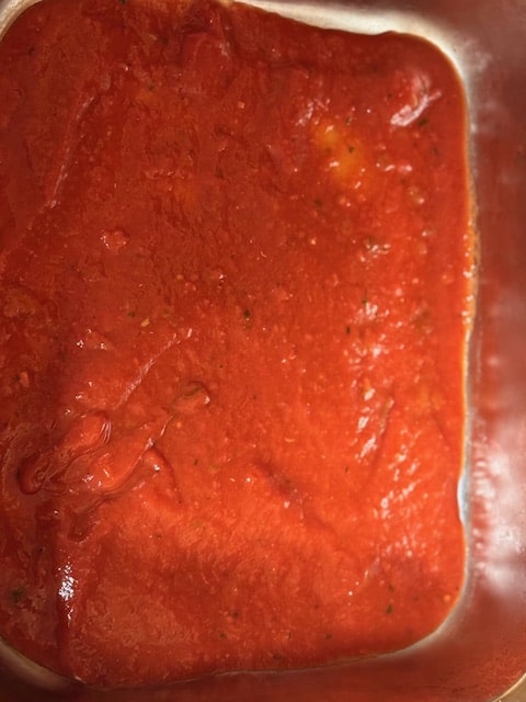 spread sauce on bottom of pan