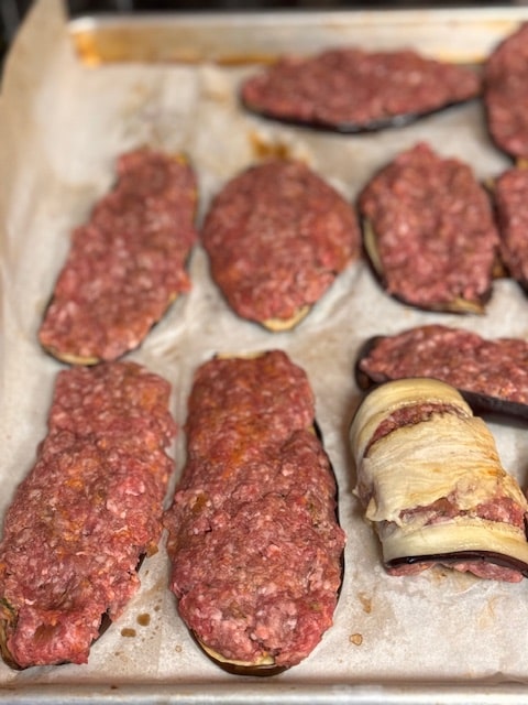 patting meat onto slices of eggplant