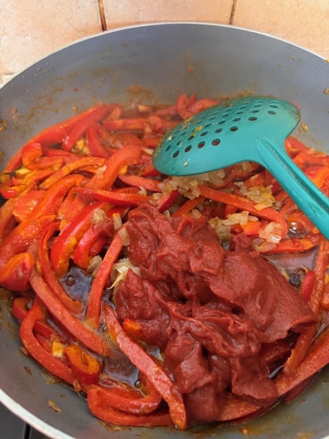 adding the tomato paste and sauteed onion