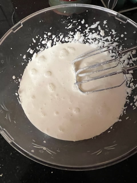 adding the whipped cream on top of the whipped cream cheese