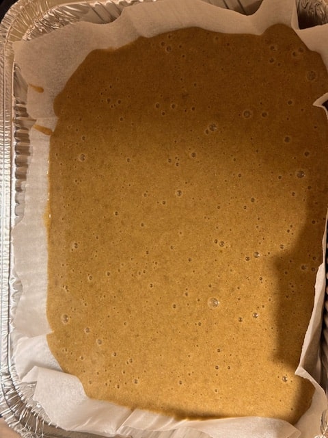 pour batter into parchment lined pan