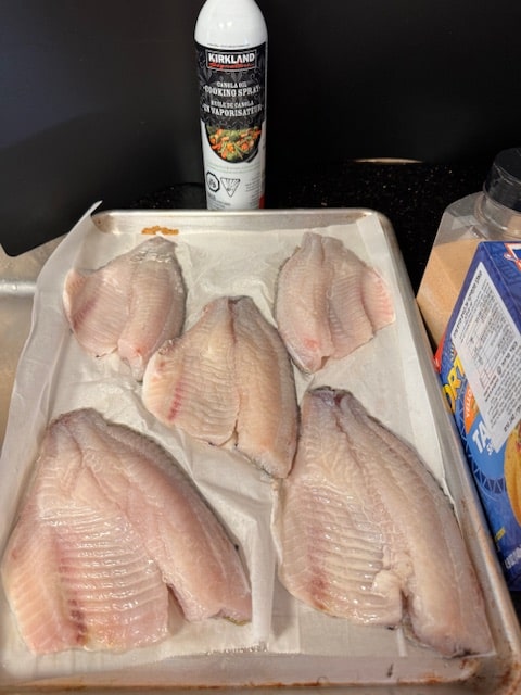 fish on parchment paper on pan