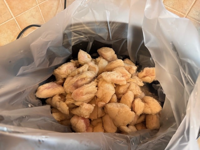 place the chicken bites in the crockpot liner bag