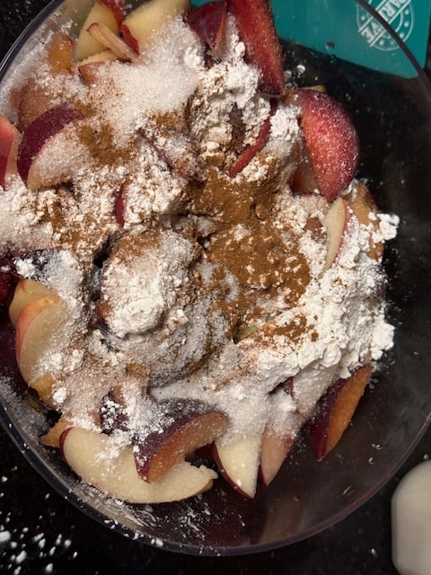 sprinkling the fruit with the sugar, spices and cornstarch