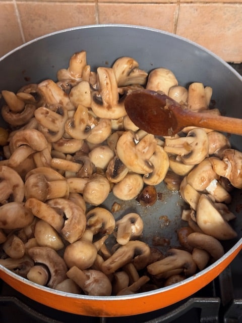 sautéeing the mushroom with the onions