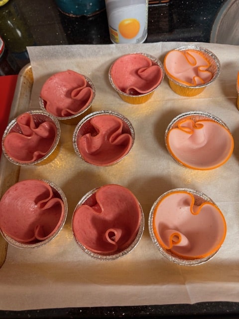 folding the salami into the tins