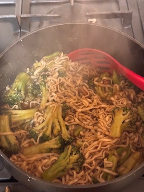 Add cooked noodles on top of broccoli