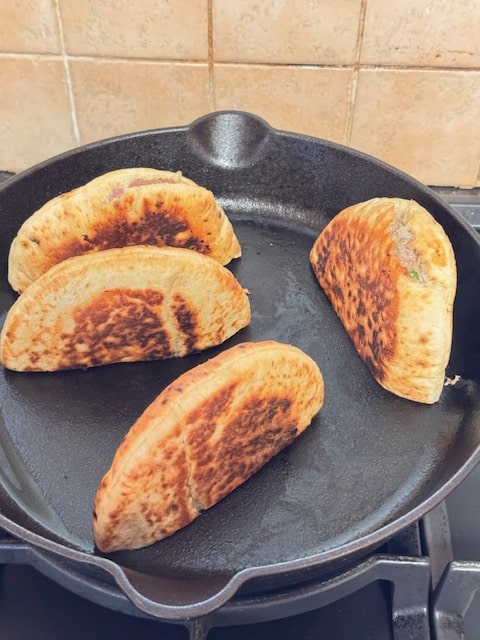 browning the meat, standing pita up