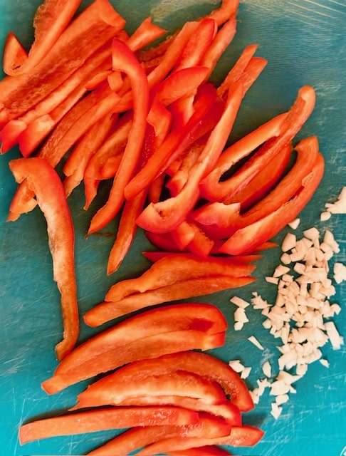 sliced red peppers and chopped garlic