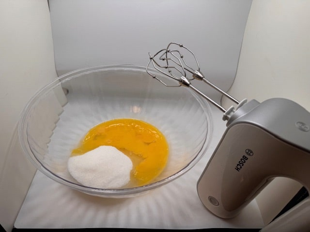 place eggs and sugar in bowl