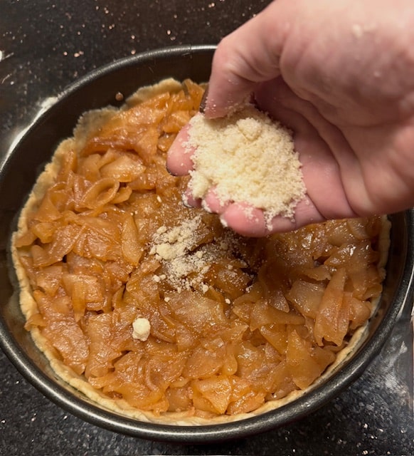Sprinkling the crumb topping on the pie