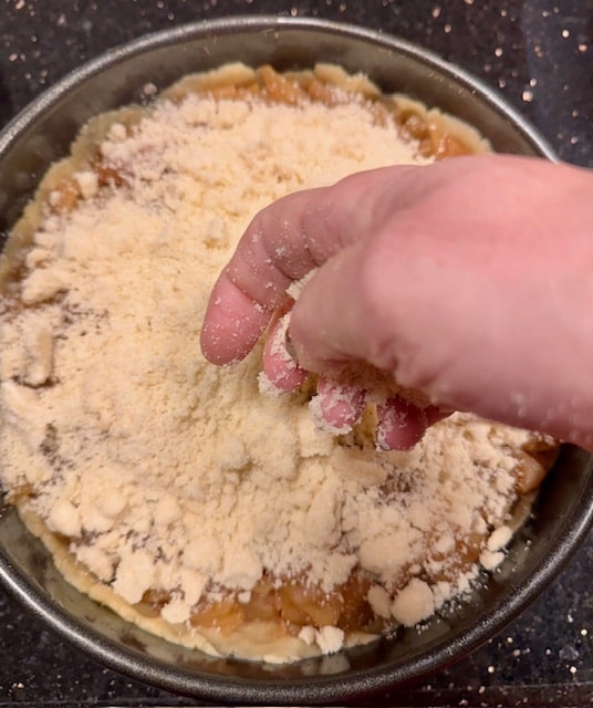 Nearly done, the topping covers the whole pie, no worries