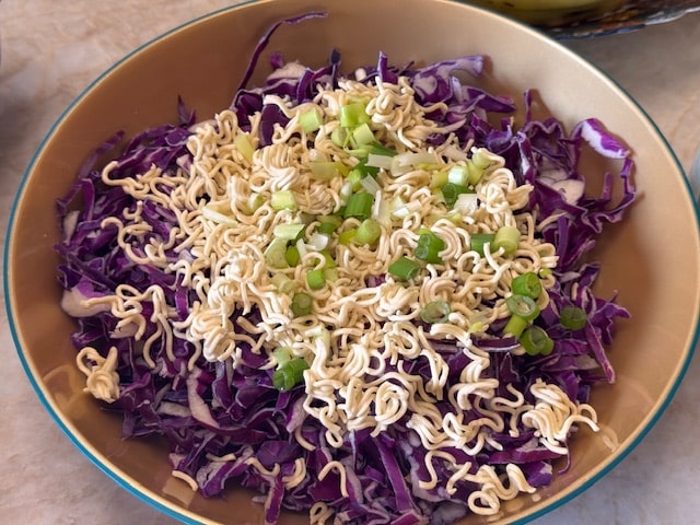 ramen noodles crumbled over cabbage